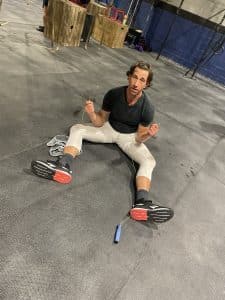Mike on the floor of his gym with a broken jumprope